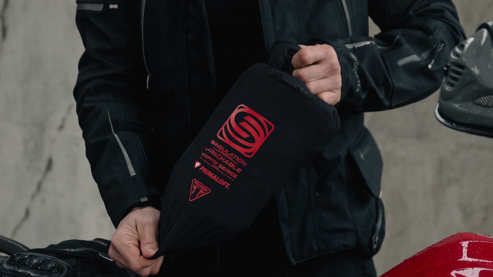 Man holding packable clothing in bag