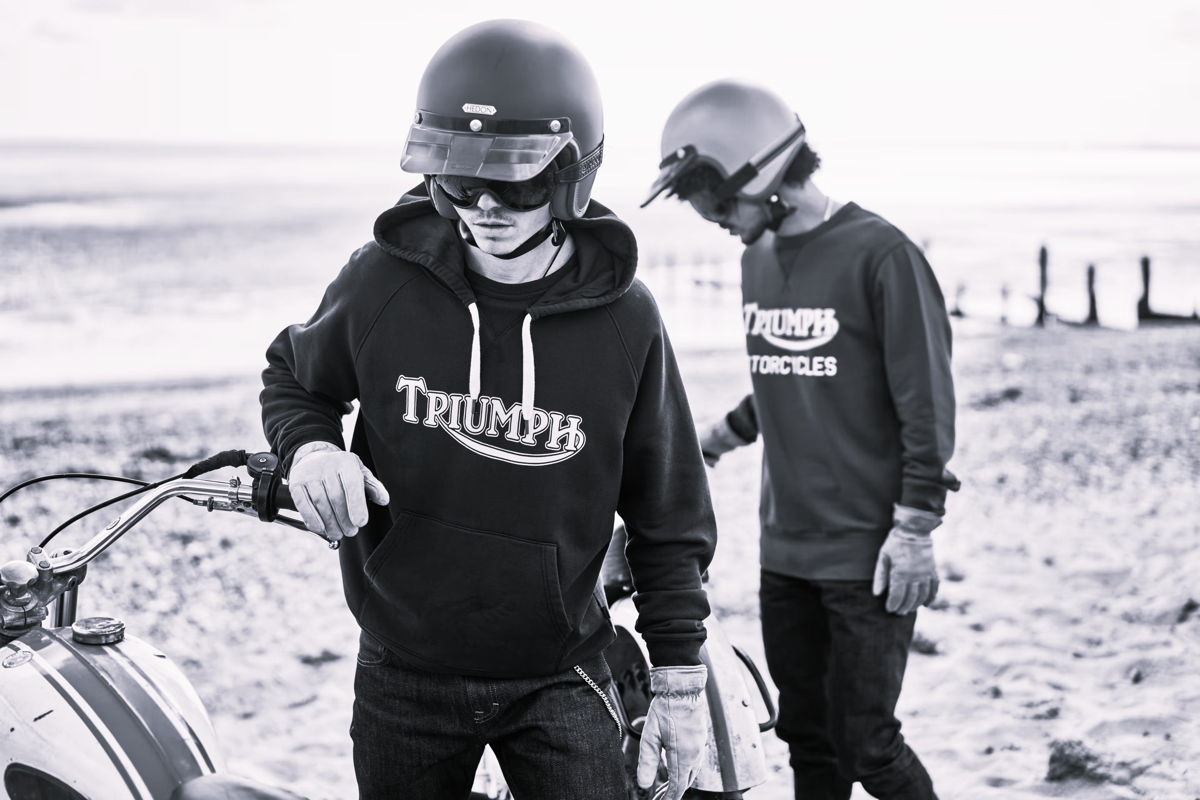 Two men outside wearing a triumph motorcycles hoodies